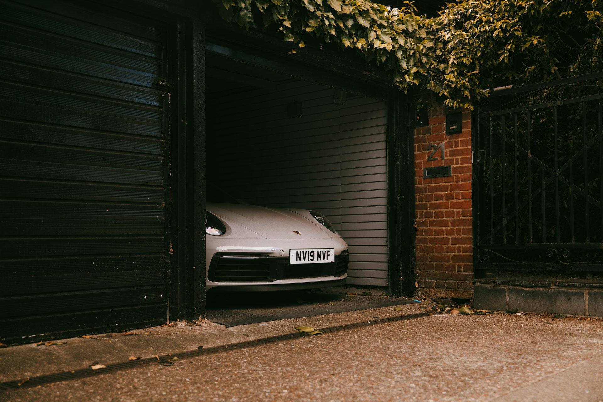 A white car is inside an open garage.
